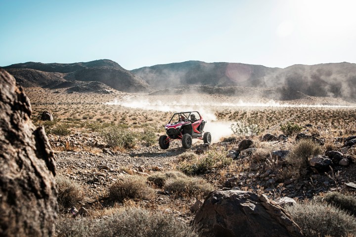 a motorcycle parked on the side of a dirt field