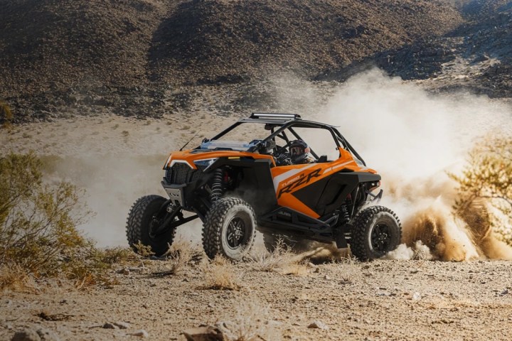 a car driving down a dirt road